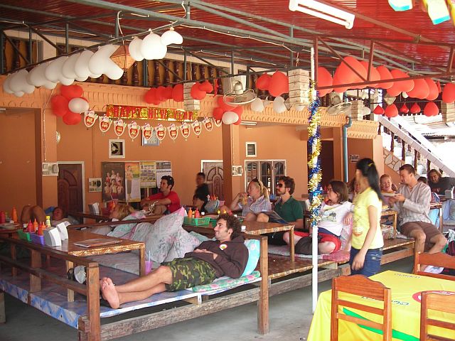 bagpacker enjoing a daily soap in a videobar in Vang Vieng; Laos